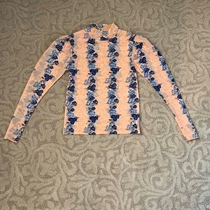Free People peach w/blue floral design turtleneck. 90%nylon, 10%elastane. Size S